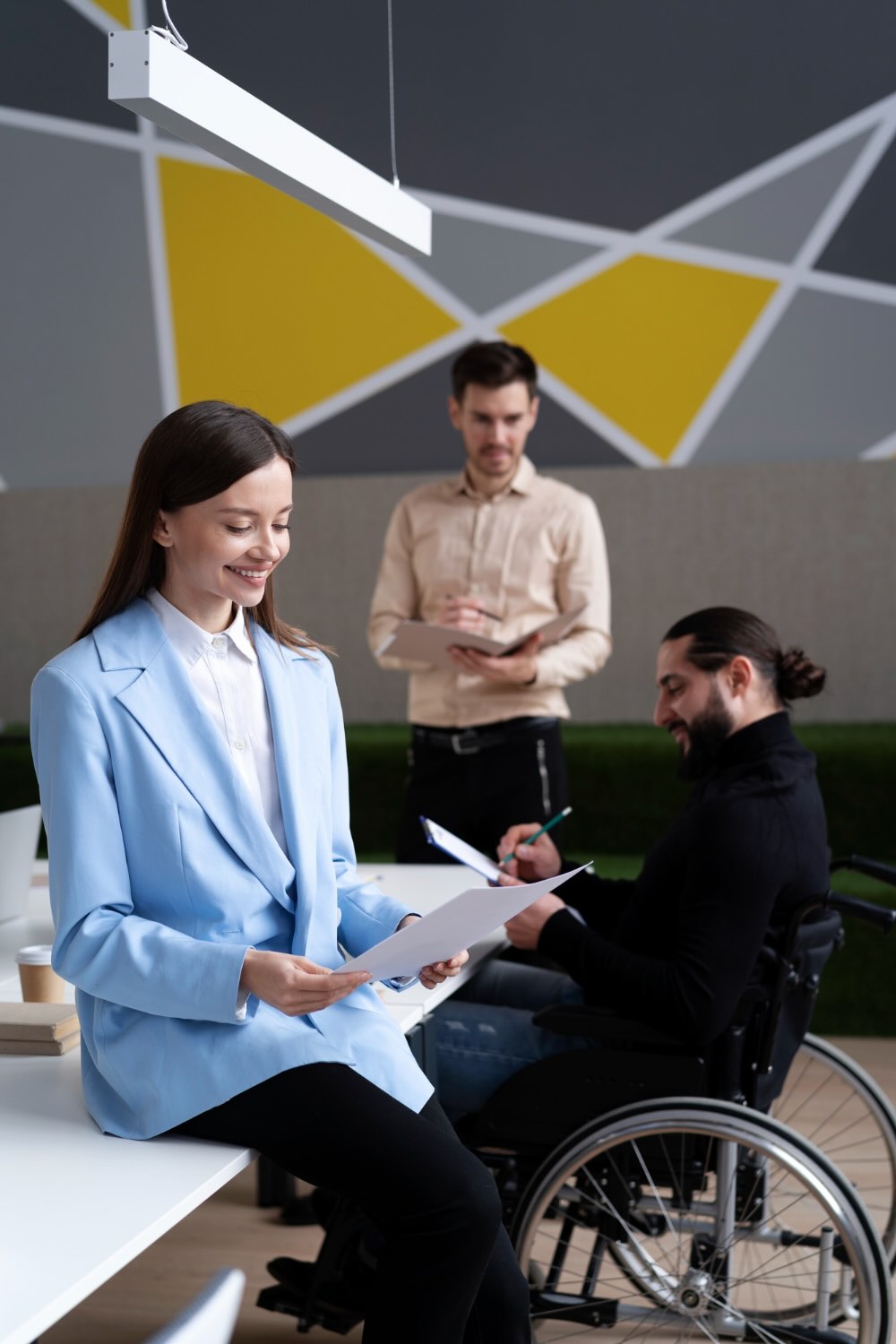 Psychosocial Hazards - Promoting Inclusivity in the Workplace Team discussion addressing psychosocial hazards in an inclusive workspace, with diverse team members including a wheelchair user